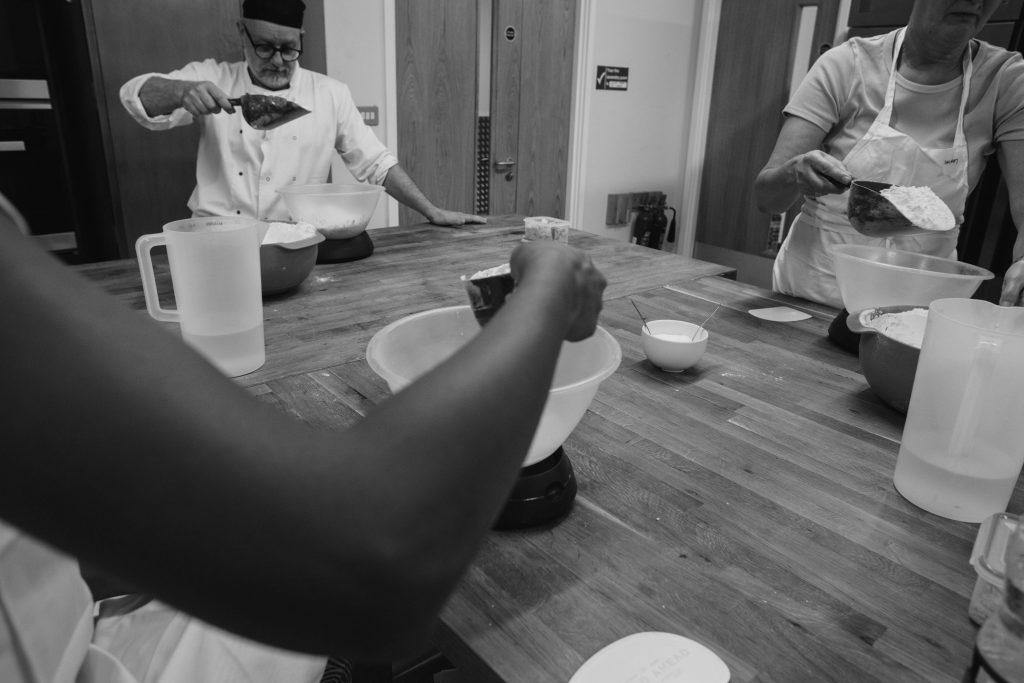 Mixing Flour Into A Bowl